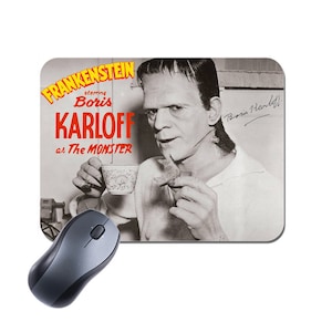 May include: A black and white photograph of Boris Karloff as Frankenstein's Monster, holding a cup and a small object. The image is a movie poster for the film "Frankenstein" starring Boris Karloff as "The Monster".