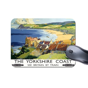 May include: A vintage travel poster for the Yorkshire Coast in England. The poster features a colourful illustration of a seaside town with a beach and blue water. The text on the poster reads "The Yorkshire Coast, See Britain by Train, British Railways".