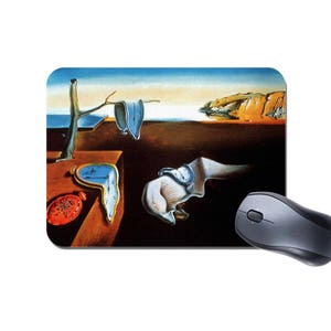 May include: A surrealist art mousepad featuring a melting clock, a tree branch, and a figure with a pocket watch. The background is a blue sky with a distant landscape.