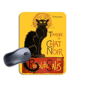 以下が含まれることがあります： 黒い猫のイラストが描かれた黄色のマウスパッド。猫は「Tournée du Chat Noir de  Rodolphe Salis」という黒と白の文字が書かれた赤いバナーの上に座っています。「Prochainement」という文字が右上の隅にあります。