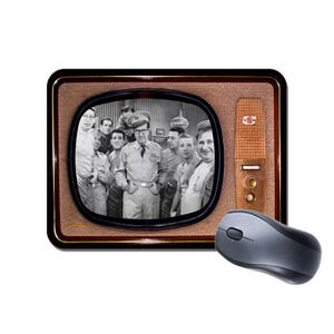 May include: A vintage television set with a black and white image of a group of men in military uniforms. The television is brown with a gold trim and a microphone on the side. A computer mouse is in the foreground.