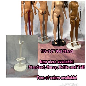 May include: A white doll stand with a curved top and a circular base. The image also shows several doll stands supporting dolls of various skin tones. Text on the image reads "10-12" Doll Stand" and "New sizes available! Standard, Curvy, Petite and Tall!"