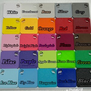 May include: A collection of small, square color swatches in various shades, including white, translucent, bone, silver, grey, yellow, gold, orange, red, maroon, light pink, bright pink, dark pink, plum, brown, lilac, purple, apple green, neon green, green, ice blue, sky blue, turquoise, dark blue, and black.