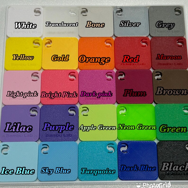 May include: A collection of small, square color swatches in various shades, including white, translucent, bone, silver, grey, yellow, gold, orange, red, maroon, light pink, bright pink, dark pink, plum, brown, lilac, purple, apple green, neon green, green, ice blue, sky blue, turquoise, dark blue, and black.