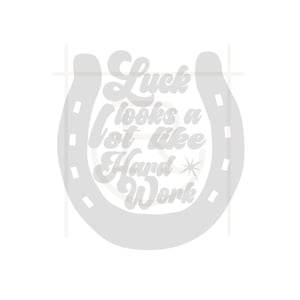 May include: A light gray horseshoe design with the text "Luck looks a lot like Hard Work" in a stylized font. A star graphic is included in the design. The image is on a white background.