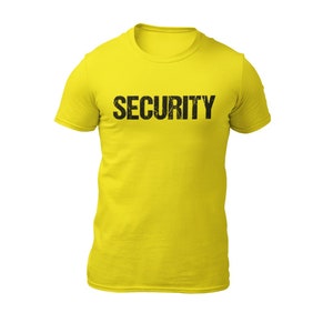 May include: A yellow t-shirt with the word "SECURITY" printed in black on the front.
