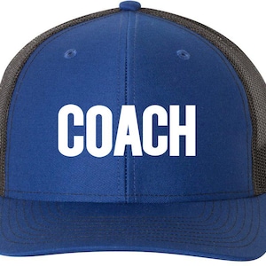 May include: A royal blue trucker hat with a black mesh back. The hat has white text that reads "COACH".