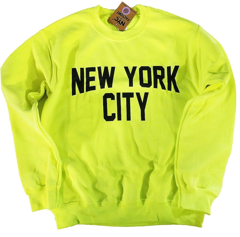 May include: A neon yellow sweatshirt with black text that reads "NEW YORK CITY".