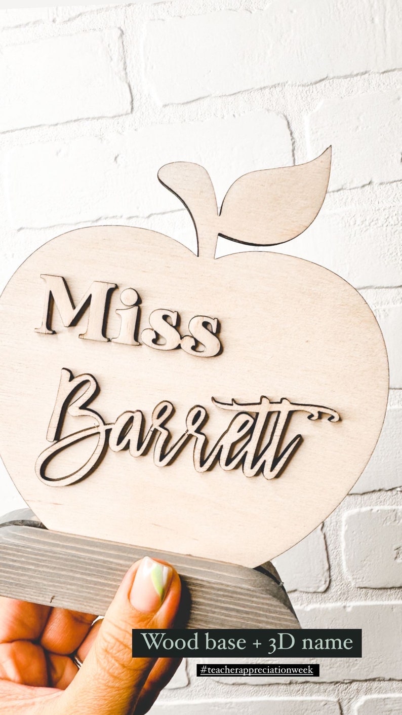 May include: A wooden apple with a 3D name cutout that reads "Miss Barrett". The apple is on a wood base. The text "Wood base + 3D name" is below the apple. The hashtag "#teacherappreciationweek" is below the text.