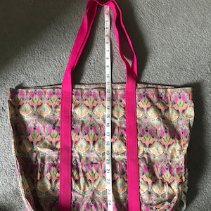 Handmade tote bag made from Liberty fabric. Strong webbing makes for good handles. 16” deep x 21” wide.