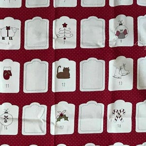 Moda fabric panel for 50 Christmas tags and 2 envelopes can be used for advent calendars. Preowned and started a couple of tags.