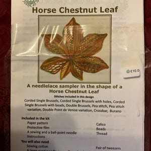 May include: A needlelace sampler kit with a Horse Chestnut Leaf design. The kit contains a paper pattern, protective film, needle, thread, calico, and beads. The design includes Corded Brussels and Double Point de Venise stitches. The kit also includes a pair of tweezers and scissors.