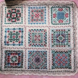 Miniature pattern, threads and instructions for an intricate cross stitch quilt design for a dolls house. Originally stitched on 48 count.