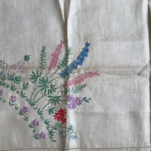 Stamped linen tablecloth with floral design in each of the four corners that needs completing. 86 cm sq.