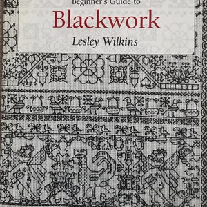 May include: A book titled "Beginner's Guide to Blackwork" by Lesley Wilkins. The cover displays detailed black and white cross-stitch patterns, including floral and geometric designs, and the text "Search Press needlecrafts".