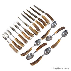 May include: A flatware set consisting of four forks, four knives, and four spoons. Each piece features a polished silver-tone metal head and a textured, brown, natural-looking antler handle. The text artfour.com is visible in the bottom right corner.