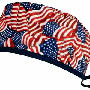 May include: A blue and black surgical scrub hat with a pattern of red, white, and blue American flags.