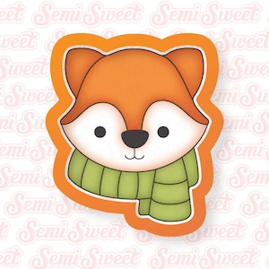 May include: A cartoon fox wearing a green scarf. The fox has orange fur, a white face, and black eyes. The fox is smiling.