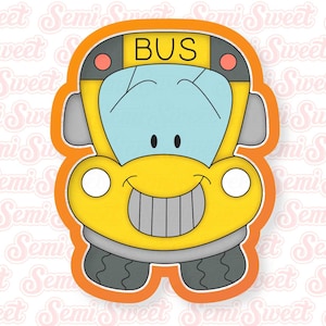 May include: A yellow cartoon bus cookie cutter with a smiling face, black wheels, and the word "BUS" on the front.
