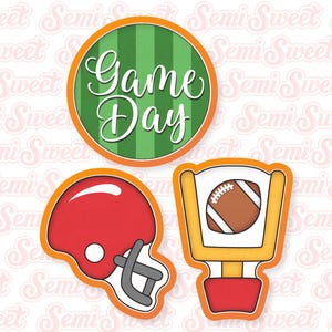 May include: Three cookie cutters for football themed baking. The cutters are orange with a green and white striped circle that says "Game Day", a football helmet, and a football goal post.
