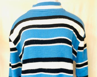 May include: A blue, black, and white striped sweater with a mock neck.