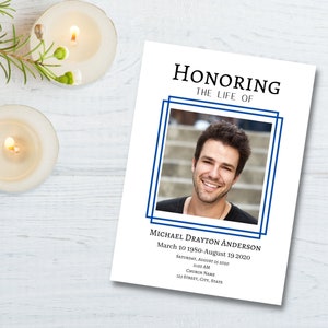 May include: A white memorial card with a blue border. The card has a photo of a man smiling at the camera. The text "HONORING THE LIFE OF" is at the top of the card. The text "MICHAEL DRAYTON ANDERSON" is below the photo. The text "March 10 1950-August 19 2020" is below the name. The text "SATURDAY, AUGUST 25 2020" is below the dates. The text "11:00 AM" is below the date. The text "CHURCH NAME" is below the time. The text "123 STREET, CITY, STATE" is below the church name.