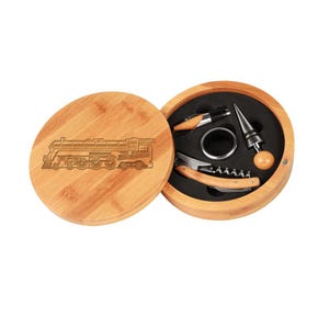 May include: A wooden box with a train engraved on the lid, containing a wine opener, a bottle stopper, and a foil cutter.
