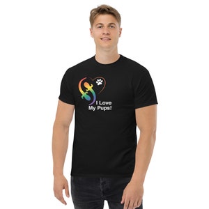 May include: A black t-shirt featuring a rainbow heart and paw print design. The text "I Love My Pups!" is printed below the heart.