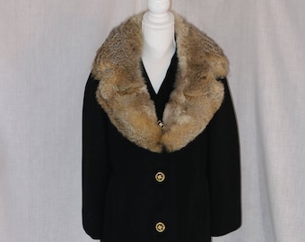 May include: A black wool coat with a large brown fur collar. The coat has three gold buttons down the front.