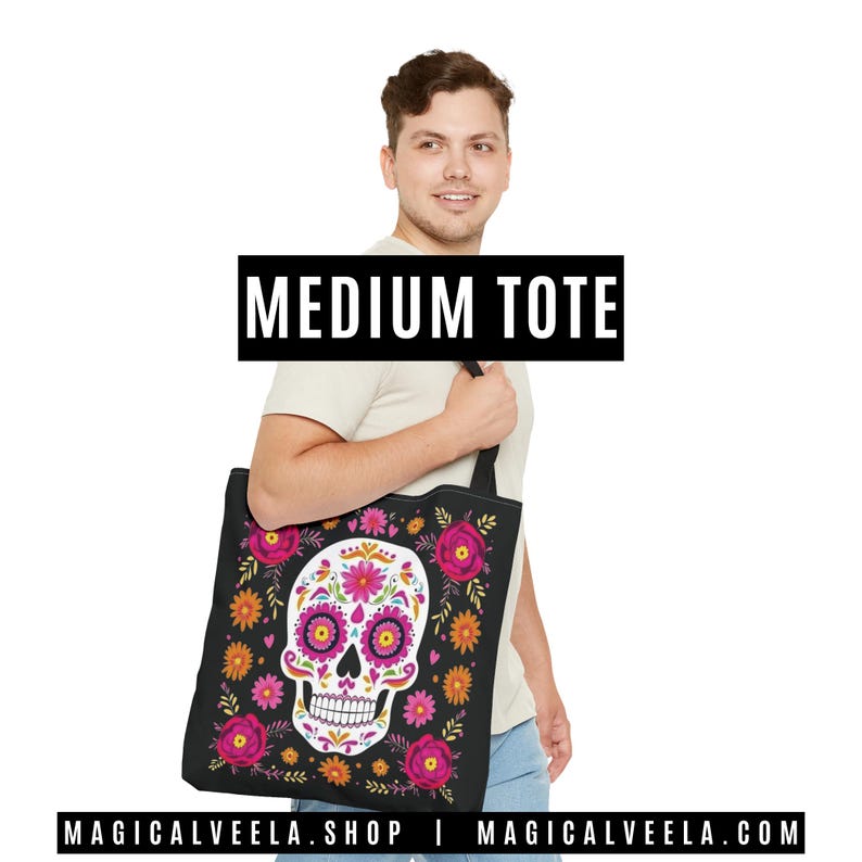 May include: Black medium tote bag featuring a colorful sugar skull design with pink, orange, and yellow floral accents. The tote bag has a black handle and the text "MEDIUM TOTE" in a black rectangle.
