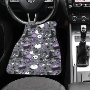 May include: Two car floor mats with a black and purple Halloween themed pattern featuring ghosts, bats, and witch hats.