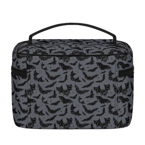 May include: A gray and black toiletry bag with a bat pattern. The bag has a black zipper and a black handle.