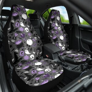 May include: Car seat covers with a Halloween-themed pattern. The design features a repeating pattern of witch hats, cauldrons, ghosts, skulls, pumpkins, and other spooky elements in black, white, and purple on a gray background.