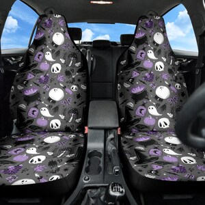 May include: Two car seat covers with a Halloween-themed pattern. The design features white ghosts, skulls, cauldrons, witch hats, and pumpkins on a gray background, with purple accents. The seats are designed to fit most car models.