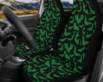May include: A pair of black car seat covers with a green bat pattern. The covers are made of a soft, comfortable fabric and are easy to install.