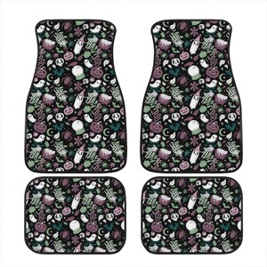 May include: Set of four black car floor mats with a Halloween-themed print. The print features ghosts, pumpkins, witches, and other spooky elements in shades of green, purple, and white on a black background.