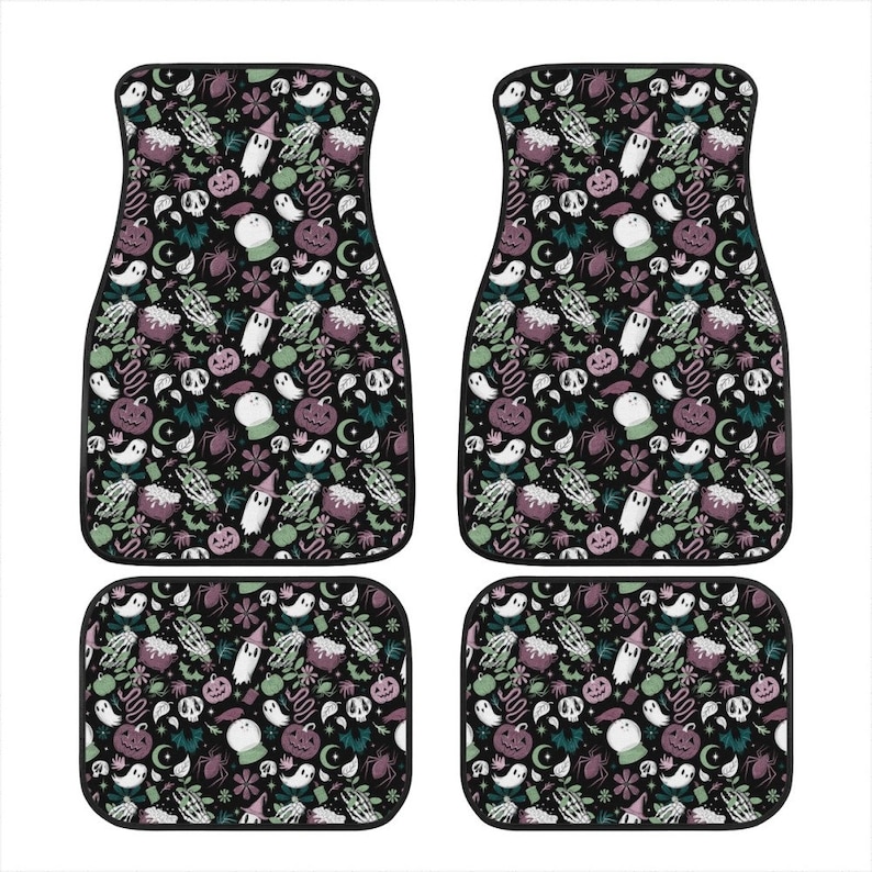 May include: Set of four black car floor mats with a Halloween-themed print. The print features ghosts, pumpkins, witches, and other spooky elements in shades of green, purple, and white on a black background.