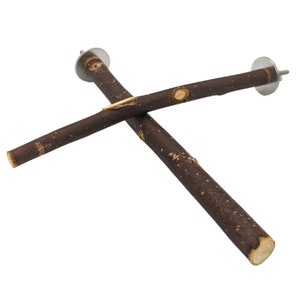 May include: A brown wooden bird perch with metal hooks on each end. The perch is shaped like a cross.