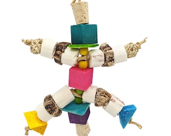 May include: A colorful bird toy made of natural materials. The toy features wooden blocks in various colors, cork pieces, and woven spheres, all connected with rope. The design is intended for bird enrichment and play, with a variety of textures and shapes.