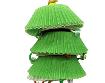 May include: A green paper cupcake liner Christmas tree ornament with colorful beads and a rope hanger.