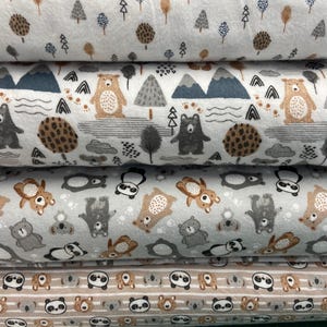 May include: Three fabric swatches with different animal prints. The top swatch is white with brown and gray animal silhouettes. The middle swatch is gray with brown and white animal silhouettes. The bottom swatch is brown with white and gray animal silhouettes.