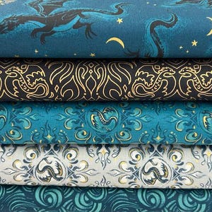 May include: Five stacked bolts of fabric featuring dragon motifs. The top layer is teal with black dragons and yellow moons. The second is black with gold dragon patterns. The third is teal with gold dragon medallions. The fourth is white with grey and gold dragon designs. The bottom is teal with swirling patterns.