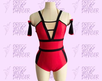 May include: A red leotard featuring black trim, a deep V-neckline with horizontal straps, and off-the-shoulder sleeves. The garment is displayed on a mannequin against a light purple background with the repeating text DRESS YOUR DANCER.
