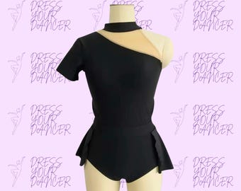 May include: A black leotard featuring a mock neck, a short sleeve on the right side, and a sheer beige mesh panel across the upper chest and left shoulder. The garment includes a fitted bodice and a short, flared skirt attached at the waistline.