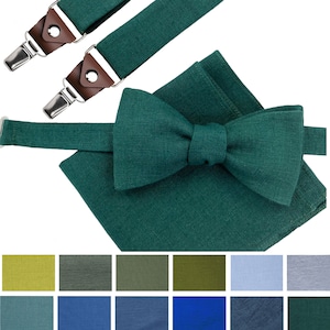 May include: A set of green suspenders and a matching bow tie. The suspenders have brown leather accents and silver clips. The bow tie is made of a textured fabric. The set is available in a variety of colors.