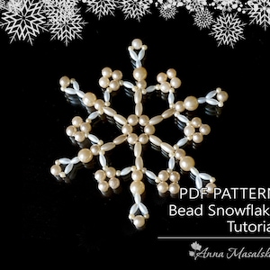 May include: A white and cream beaded snowflake ornament with a black background. The image includes the text "PDF PATTERN Bead Snowflake Tutorial Anna Masalska".