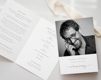 May include: Black and white funeral program with a photo of a man smiling. The program includes the order of service, a welcome and introduction, prayers, selections, tributes, eulogy, final viewing, and acknowledgements. The text "In loving memory" is written in cursive at the bottom of the program.