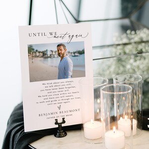 May include: A white card with a black border and a photo of a man on a beach. The card reads "Until we meet again." and "We think about you always, we talk about you still, you have never been forgotten, and you never will. We hold you close within our hearts and there you will remain, to walk and guide us through our lives, until we meet again." The card also reads "Benjamin Beaumont, Father of the Bride."