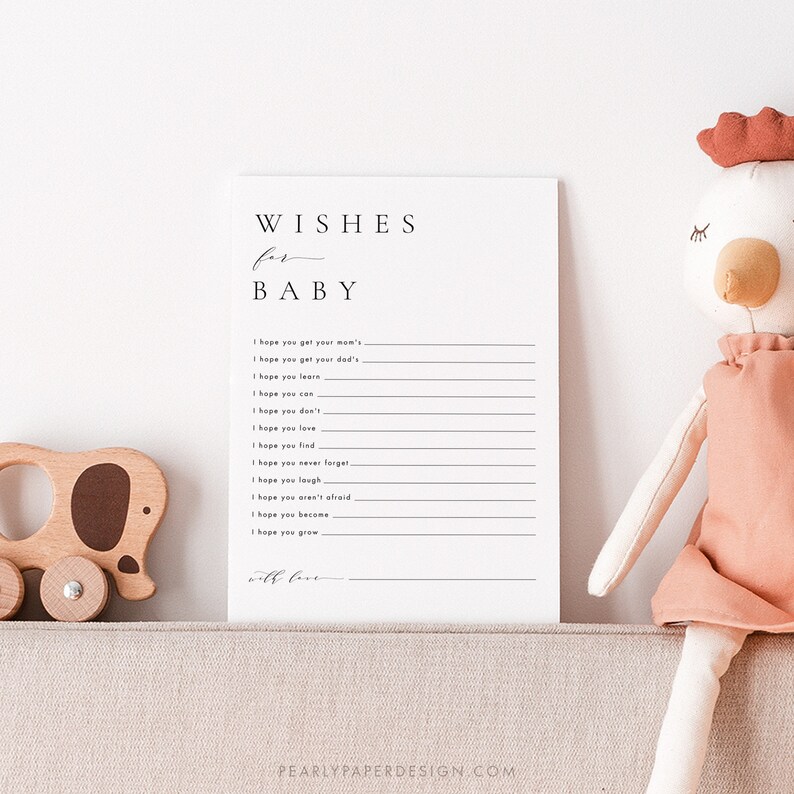 Może przedstawiać: Drukowana karta do gry na baby shower z tekstem "WISHES for BABY" i listą życzeń dla noworodka, takich jak "Mam nadzieję, że odziedziczysz... po mamie" i "Mam nadzieję, że będziesz rosnąć..."