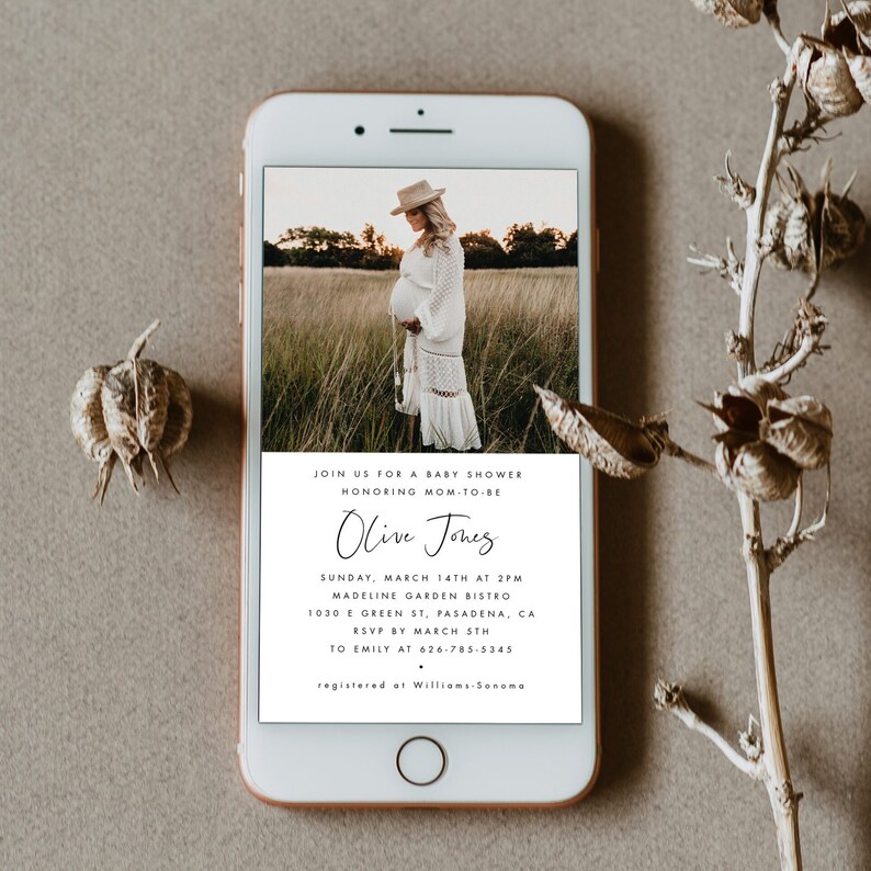 May include: A white and black baby shower invitation with a photo of a pregnant woman in a white dress and a hat. The invitation includes the text "Join us for a baby shower honoring mom-to-be Olive Jones" and details about the event.